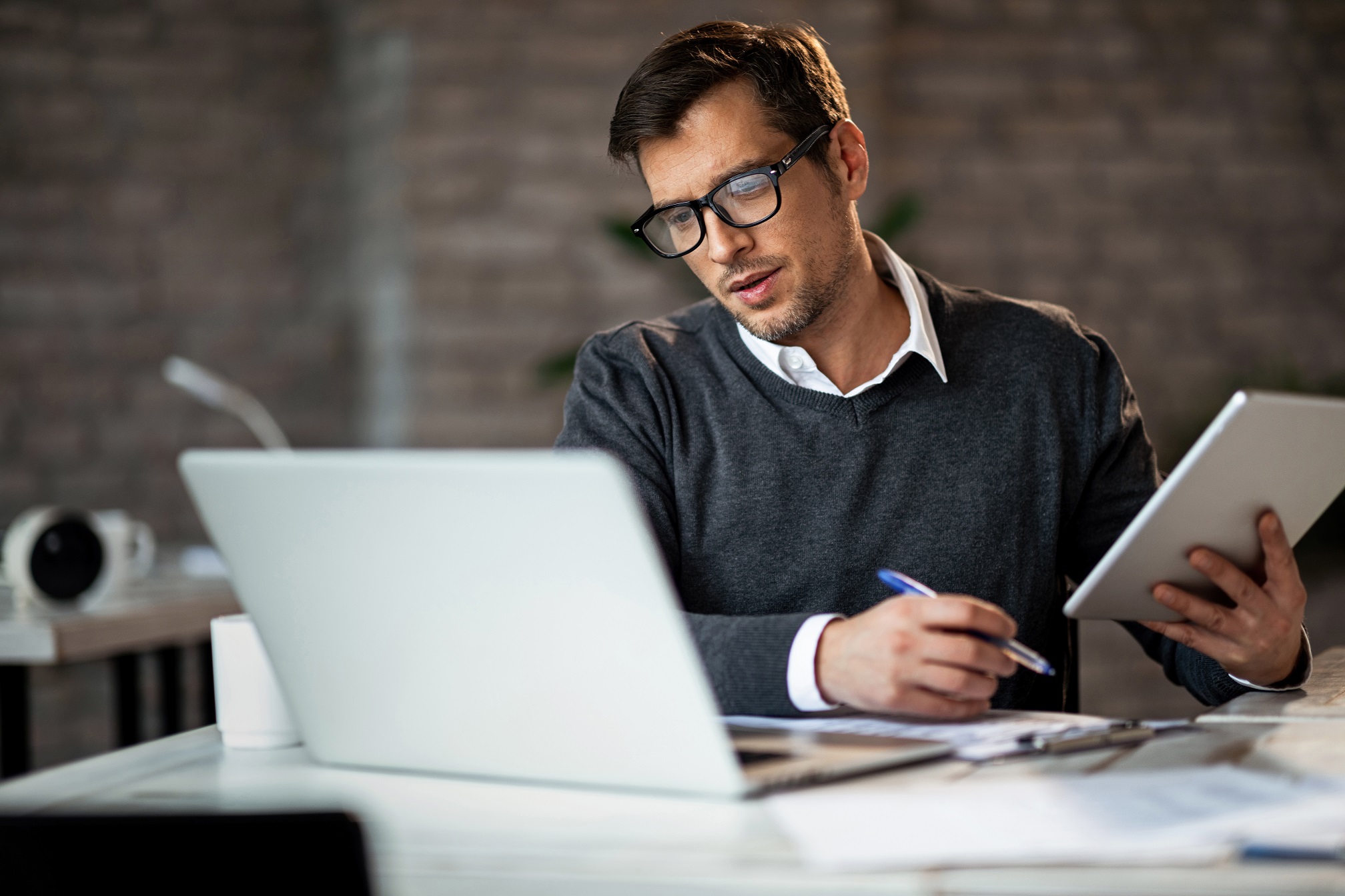 Multi-tasking,Businessman,Working,In,The,Office.,He,Is,Using,Touchpad Are You Prepared for CMMC 2.0?